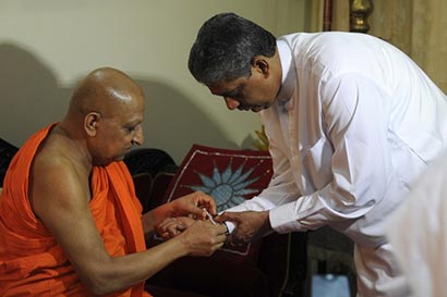 The Chief Incumbent of the Malwathu Chapter Thibbotuwawe Sri Sumangala Mahanayake Thera blesses former Sri Lanka's former army chief Sarath Fonseka 