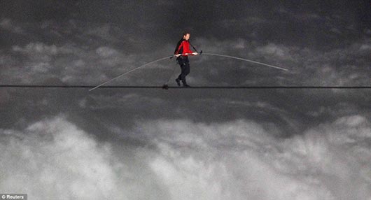 Nik Wallenda walks across the Niagara Falls in an attempt to be the first man ever to complete the walk