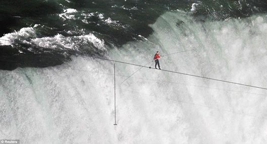 Nik Wallenda walks across the Niagara Falls in an attempt to be the first man ever to complete the walk