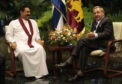 Sri Lanka’s President Mahinda Rajapaksa, left, sits with Cuba’s President Raul Castro inside Revolution Palace in Havana, Cuba