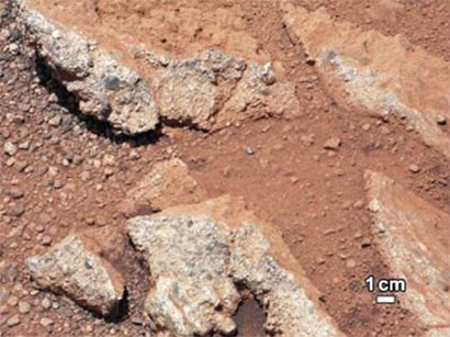 This image provided by NASA shows shows a Martian rock outcrop near the landing site of the rover Curiosity thought to be the site of an ancient streambed.