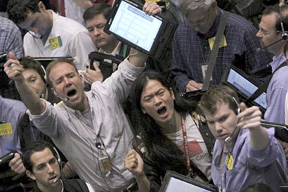 A file photo of traders working at the crude oil options pit at the New York Mercantile Exchange in New York.