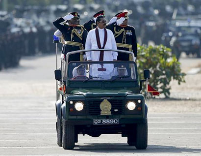 Sri Lanka's President Mahinda Rajapaksa (in white) takes part in a War Victory parade in Matara May 18, 2014