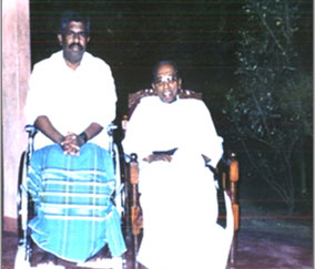 Fr. Emmanuel sitting next to castro