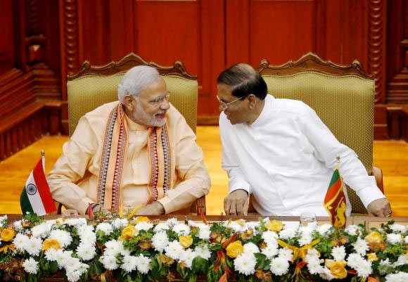 India's Prime Minister Narendra Modi talks to Sri Lanka's President Maithripala Sirisena