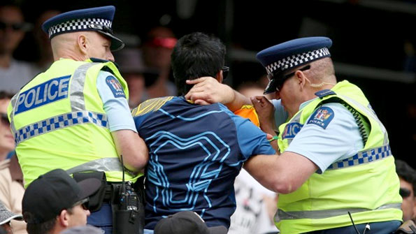   A Sri Lankan fan is removed from the Eden Park stands by police