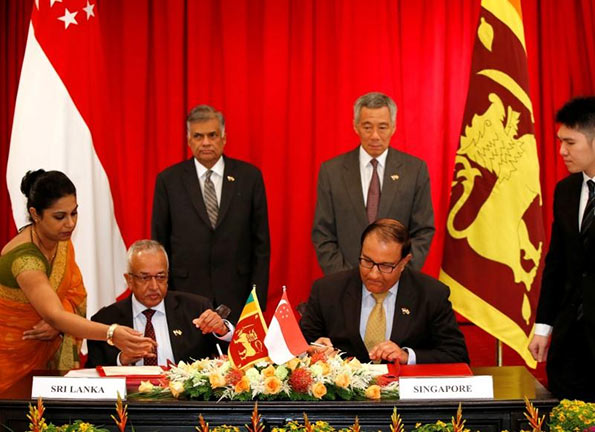 Sri Lanka's Prime Minister Ranil Wickremesinghe shakes hands with Singapore's Prime Minister Lee Hsien
