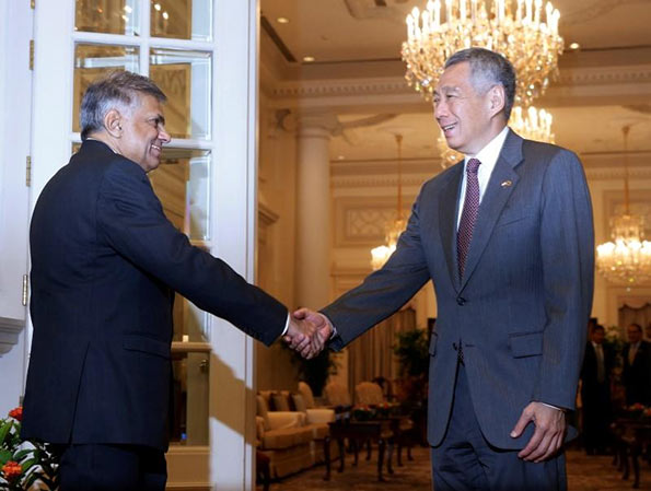 Sri Lanka's Prime Minister Ranil Wickremesinghe shakes hands with Singapore's Prime Minister Lee Hsien