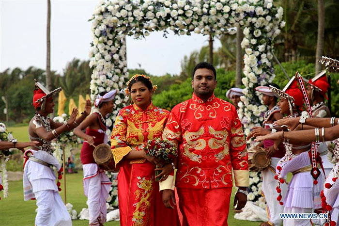 Sri Lankan and Chinese couples are seen during the mass wedding ceremony in Negombo, Sri Lanka