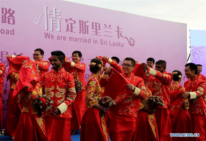 Sri Lankan and Chinese couples are seen during the mass wedding ceremony in Negombo, Sri Lanka