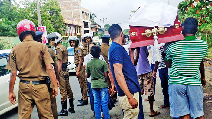 Youths carrying the victim's coffin near Athurugiriya town