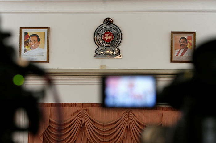 Mahinda Rajapaksa and Sri Lanka President Maithripala Sirisena's photographs on a wall