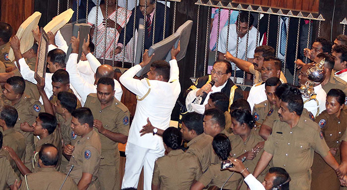 Sri Lanka police members protect Parliament Speaker Karu Jayasuriya in Parliament of Sri Lanka