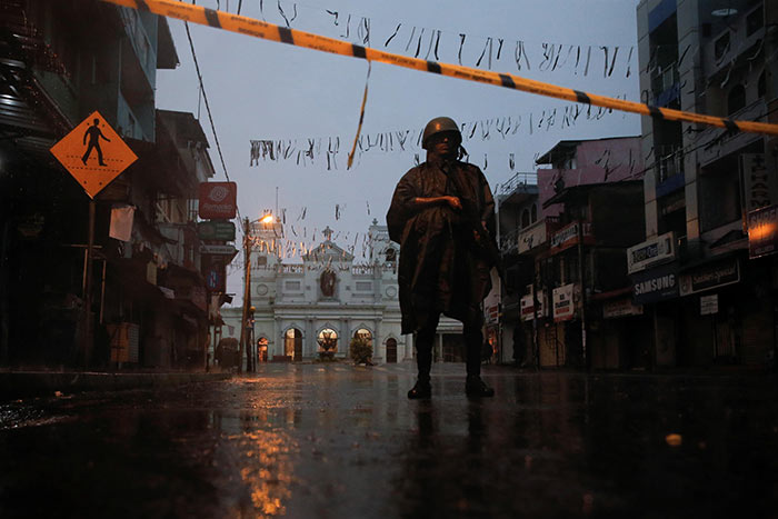 Soldier stands guard during heavy rain in Sri Lanka