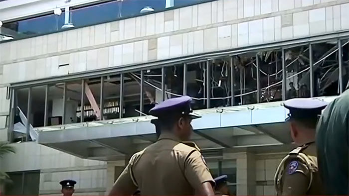 A police officer inspects the explosion area at Shangri-La hotel in Colombo Sri Lanka