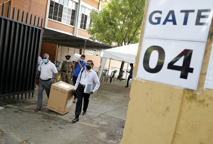 Sri Lankan polling officers carry election material