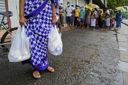 A woman carries food bags in Colombo Sri Lanka