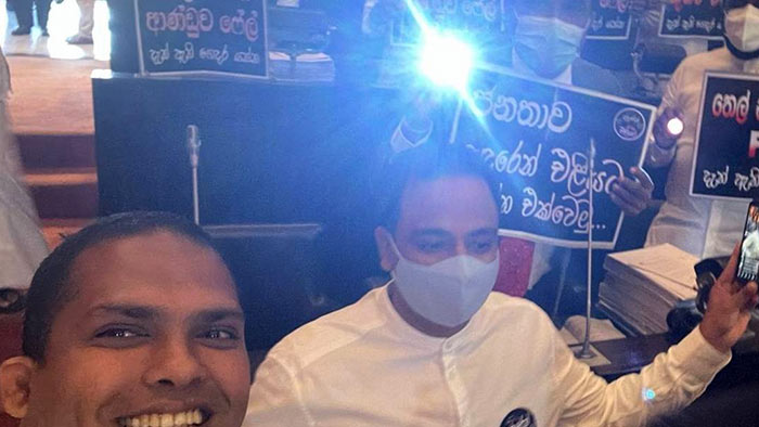 Harin Fernando brings a torch to the Parliament