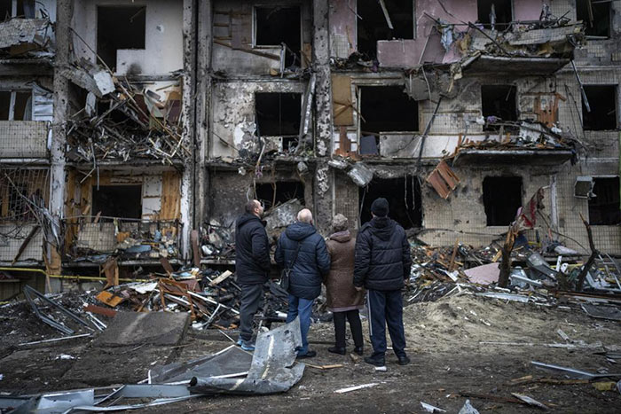People look at the damage following a rocket attack the city of Kyiv, Ukraine
