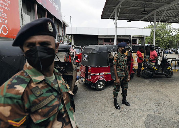Sri Lanka's Army members stand guard at a fuel station