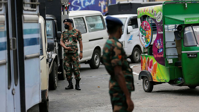 Sri Lanka's Army members stand guard at a fuel station