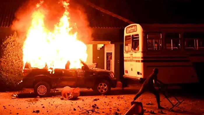 A police car burns on March 31, 2022 during a demonstration outside the Sri Lankan president's home