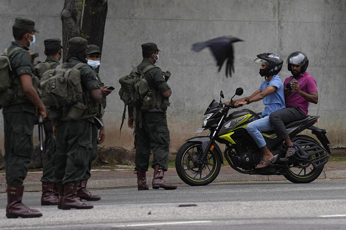 Sri Lanka Army soldiers stand guard a day after clashes between Government supporters and anti-government protesters in Sri Lanka