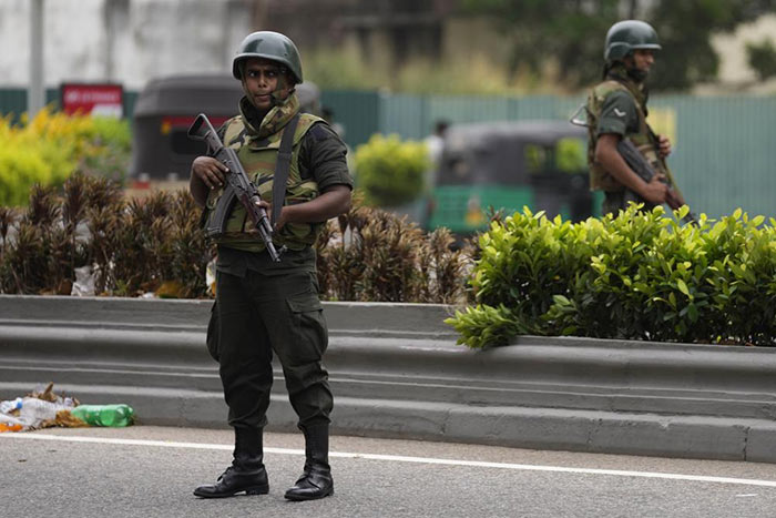 Sri Lanka Army soldiers stand guard a day after clashes between Government supporters and anti-government protesters in Sri Lanka