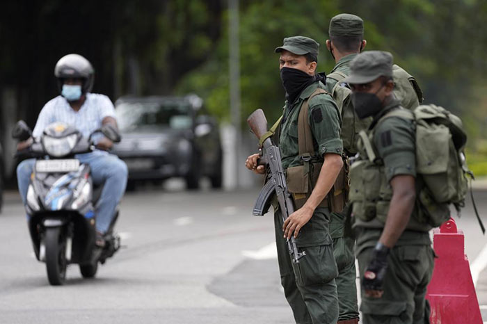 Sri Lanka Army soldiers stand guard a day after clashes between Government supporters and anti-government protesters in Sri Lanka