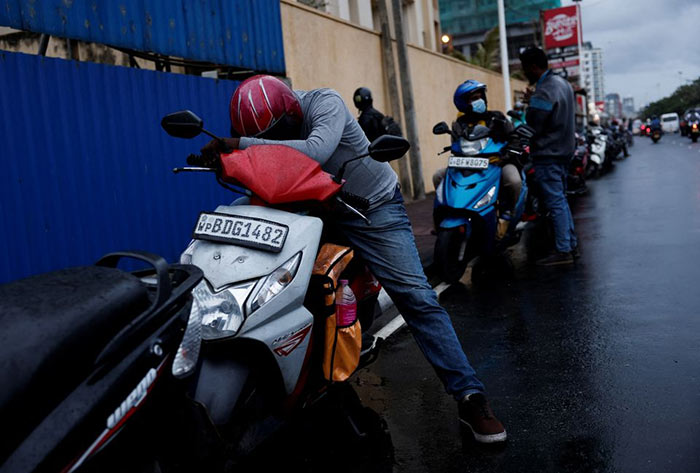 A man waits in a queue to buy petrol in Colombo, Sri Lanka