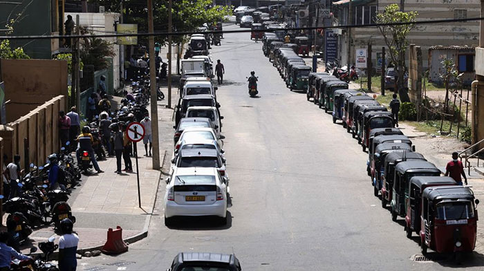 Motorbikes cars and three-wheelers wait in a queue to buy petrol in Colombo, Sri Lanka