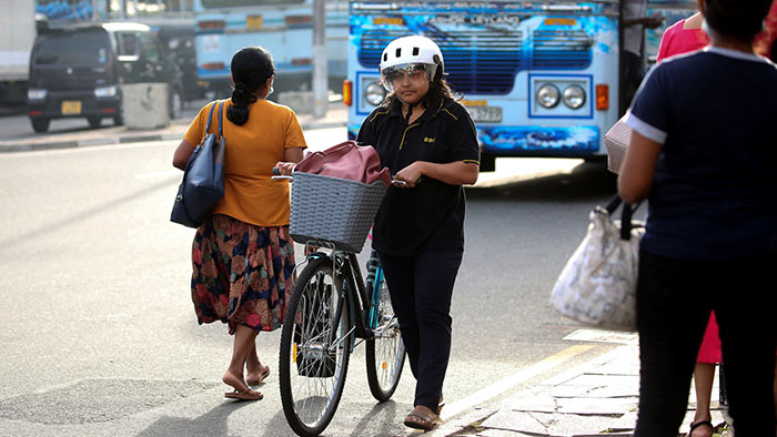 Female bicycle rider in Colombo, Sri Lanka