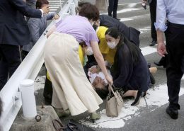 Former Japanese prime minister Shinzo Abe lies on the ground after apparent shooting during an election campaign