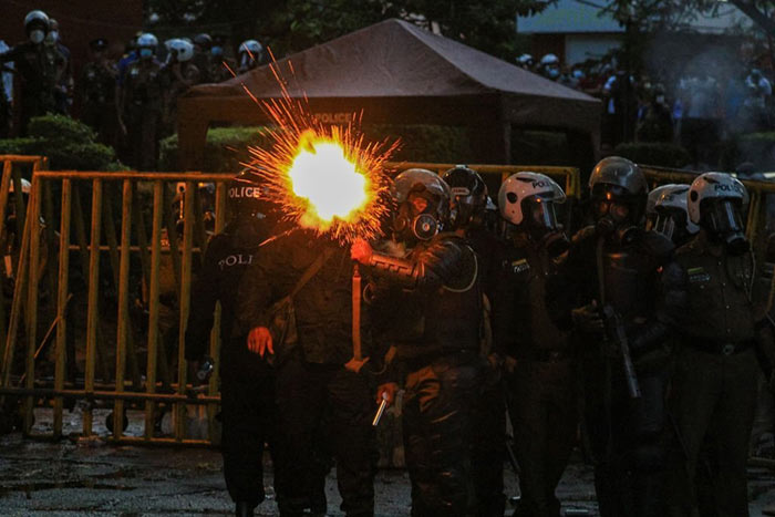 Sri Lankan Police fire tear gas at university students during a protest