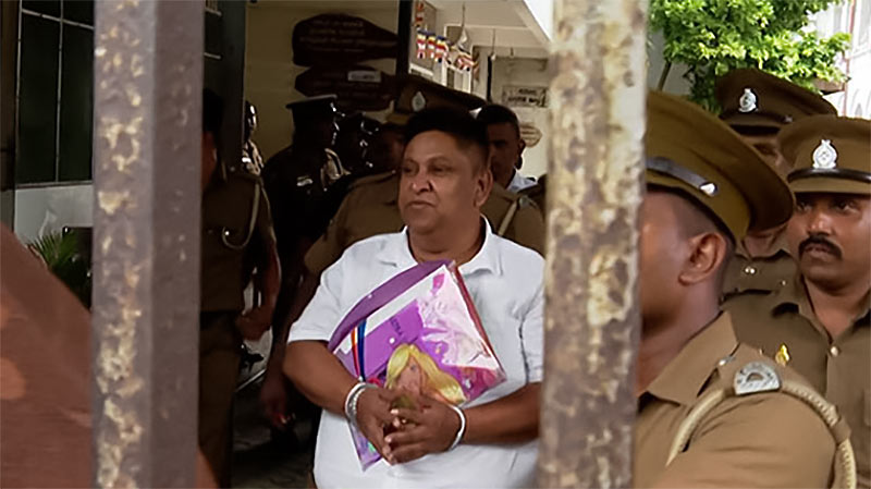 Chamara Sampath Dasanayake escorted by prison officials