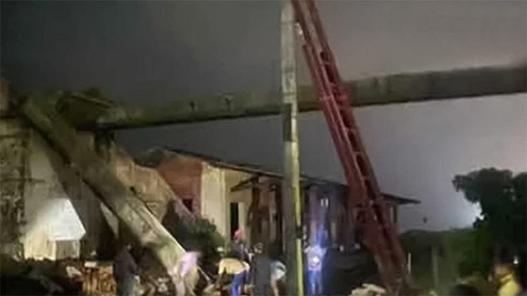 Collapsed pedestrian overpass at Egoda Uyana railway station, obstructing railway tracks