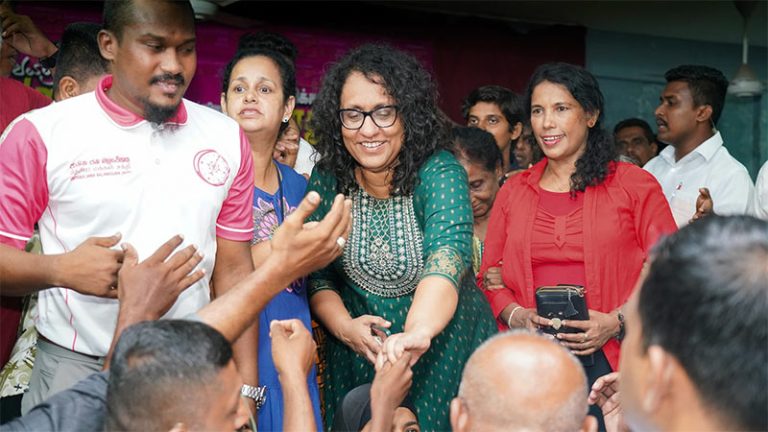 Prime Minister Dr. Harini Amarasuriya warmly greets supporters by reaching out to the crowd during a public rally in Maligawatta, Colombo