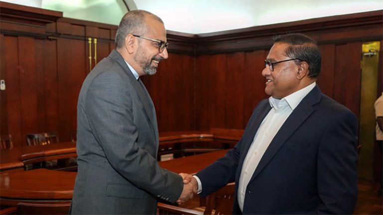 The Ambassador of Iran, Dr. Alireza Delkhosh, shakes hands with Sri Lanka’s Minister of Foreign Affairs, Foreign Employment and Tourism, Vijitha Herath