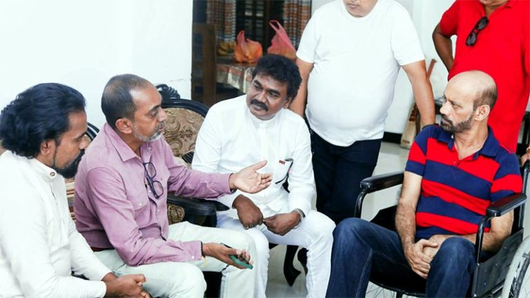 Minister Dr. Hiniduma Sunil Senevi in conversation with ailing singer Ishaq Baig during his visit
