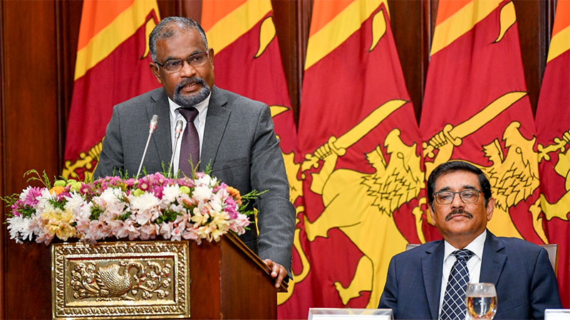 Finance Secretary Mahinda Siriwardana speaking, with Central Bank Governor Dr. Nandalal Weerasinghe seated nearby at the “Badu Shakthi” (Tax Power) programme in Colombo, Sri Lanka
