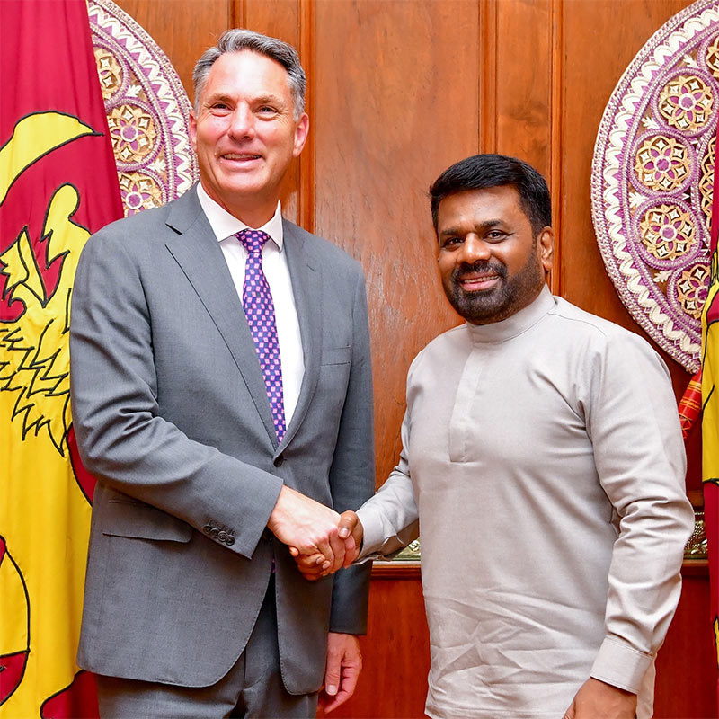Sri Lankan President Anura Kumara Dissanayake and Australian Deputy Prime Minister Richard Marles shake hands and smile at the camera