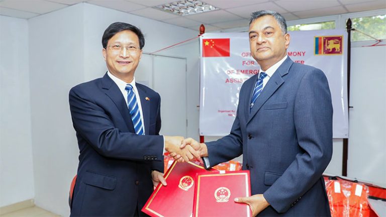 Chinese Ambassador Qi Zhenhong officially handing over humanitarian aid to Defence Secretary Air Vice Marshal (Retd) Sampatha Thuyacontha
