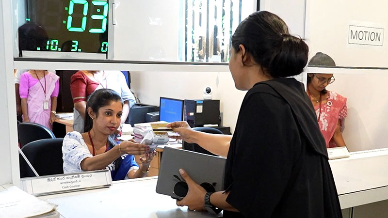 Female lawyer making a payment at a payment counter at the Supreme Court of Sri Lanka
