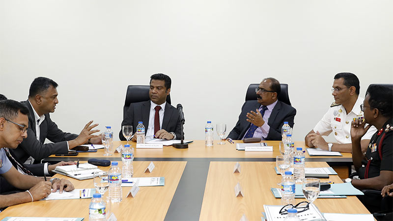 Health Minister Dr. Nalinda Jayatissa, Defence officials, and KDU leadership in a discussion at a meeting table during the hospital visit