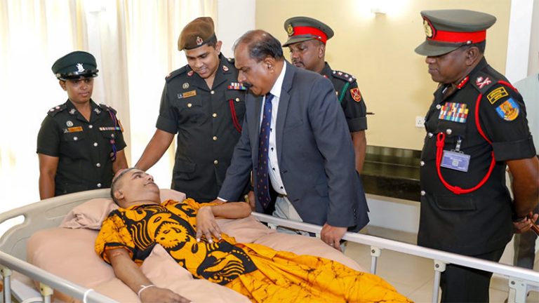 Deputy Defence Minister Aruna Jayasekara speaks with a differently-abled soldier at Mihindu Seth Medura