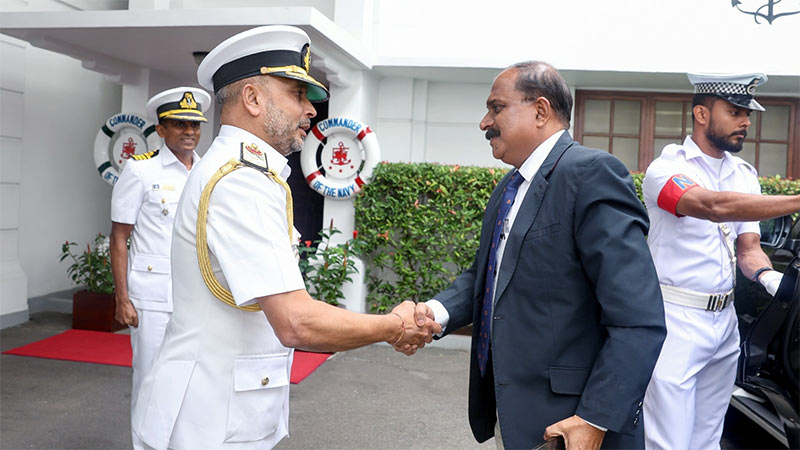 Deputy Defence Minister Aruna Jayasekara shaking hands with Navy Commander Vice Admiral Kanchana Banagoda at Navy Headquarters in Colombo