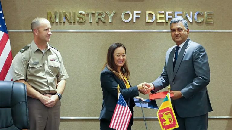 US Ambassador Julie Chung and Defence Secretary Sampath Thuyacontha shake hands after signing the agreement