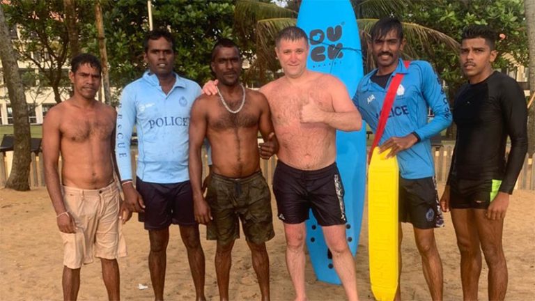 Russian national with Sri Lanka Police Lifesaving Unit officers after rescue at Kalutara beach
