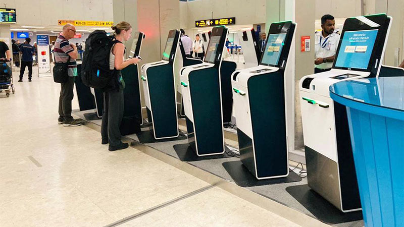 Foreign tourists using self check in kiosks at the Bandaranaike International Airport in Sri Lanka