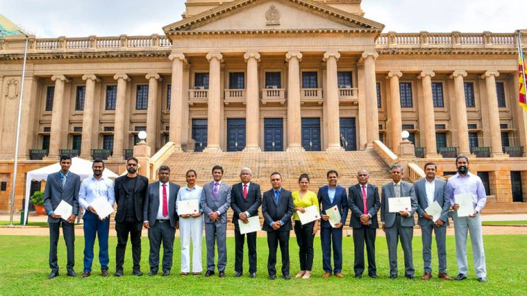Group photo of beneficiaries of NIRDC funding in front of the Presidential Secretariat in Colombo, Sri Lanka